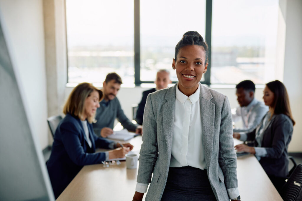 Female CEO during business meeting at corporate office looking at camera.
